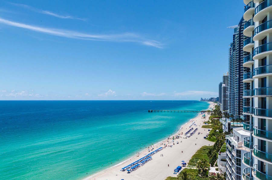 View of the Sunny Isles Beach coast with turquoise ocean waters and white sand beaches